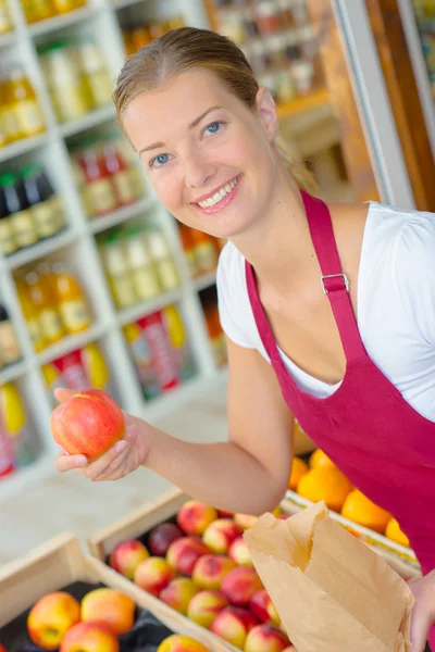 Femme travaillant sur un stand de légumes — Photo