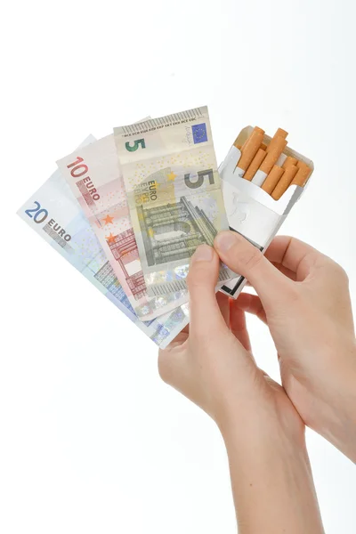 Holding cigarettes and money — Stock Photo, Image