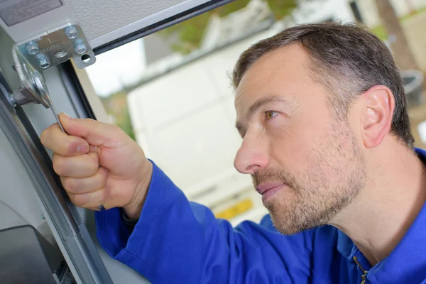 Hombre instalando una puerta de garaje — Foto de Stock