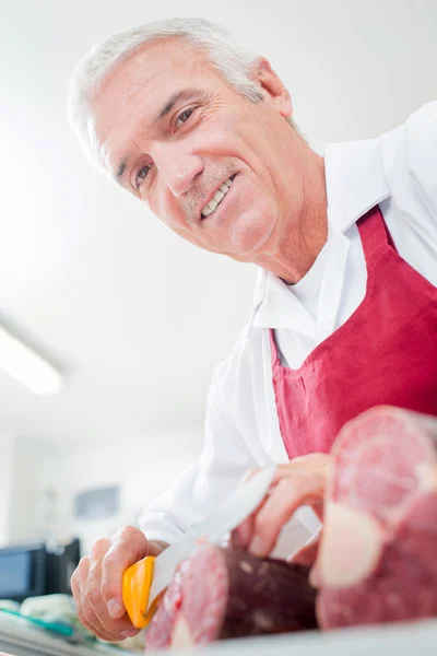 Cheerful butcher and apron — Stock Photo, Image