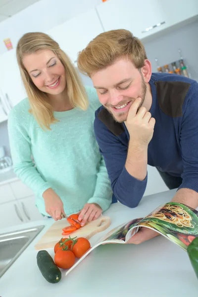 Couple following recipe from a magazine — Stock Photo, Image