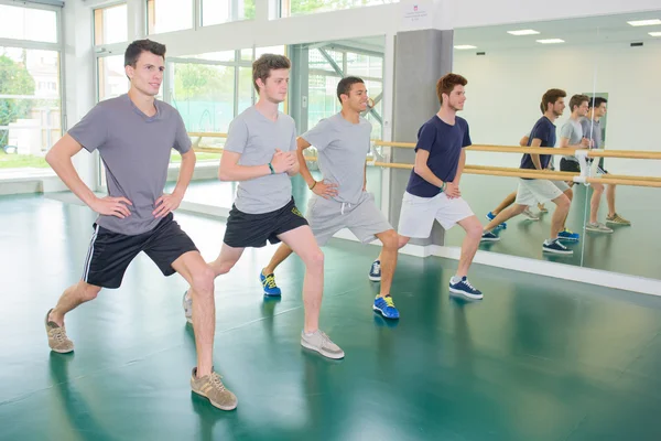 Young men stretching and four — Stock Photo, Image