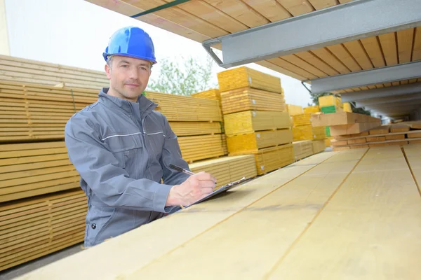 Workman in woodyard and man — Stock Photo, Image