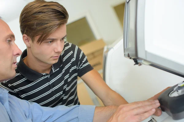 Man showing teen technological device — Stock Photo, Image