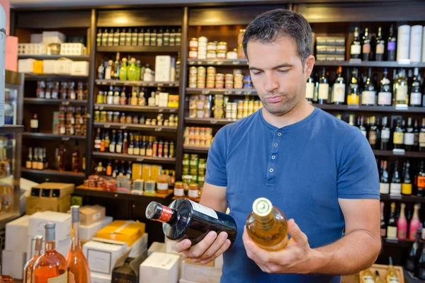 Choosing liquor and man — Stock Photo, Image