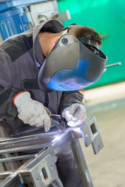 Welding a frame and man — Stock Photo, Image