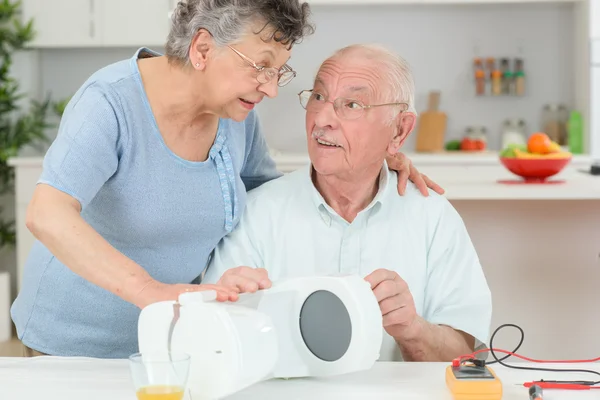 Senior citizen testen elektrische toestel — Stockfoto