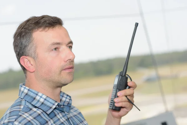 Profile of man using walkie talkie — Stock Photo, Image