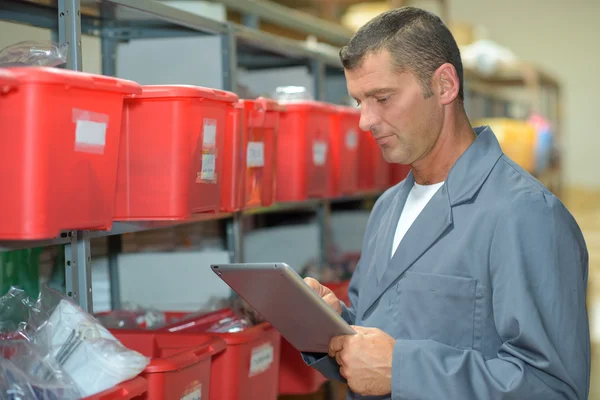 Homem no armazém usando tablet — Fotografia de Stock