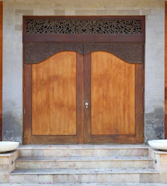 Bali tarzı ahşap kapı önünde merdiven ile