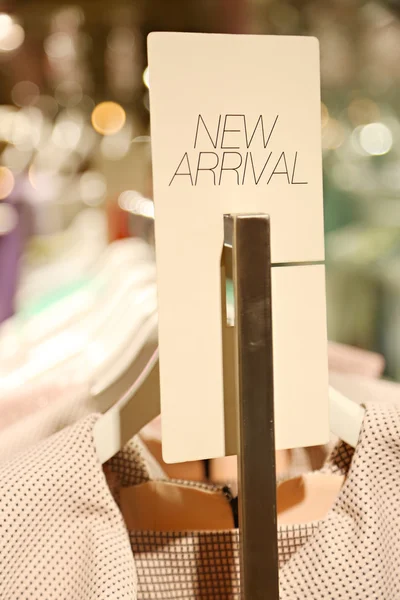 A new arrivals sign in the fashion store — Stock Photo, Image