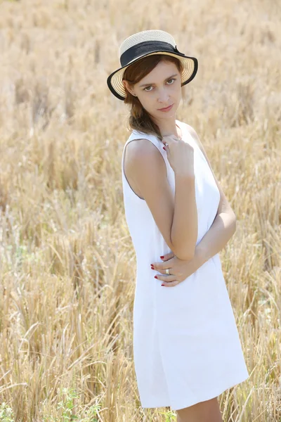 Outdoor portrait of girl in the white dress with straw hat — Stock Photo, Image