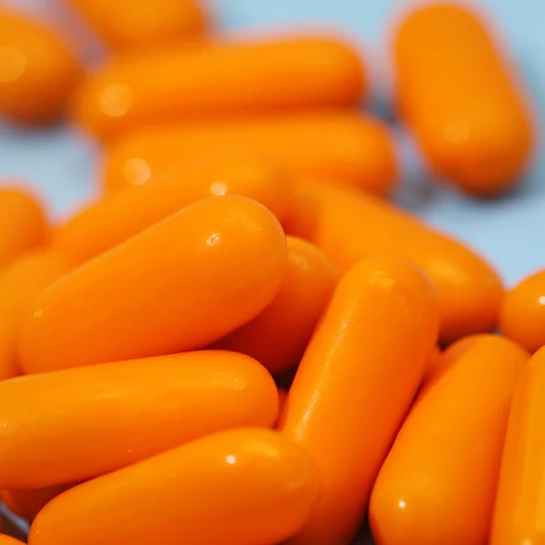 Macro view of orange pile of pills — Stock Photo, Image