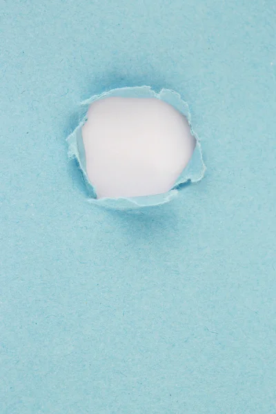 High resolution photography of hole in blue paper - visible paper texture — Zdjęcie stockowe