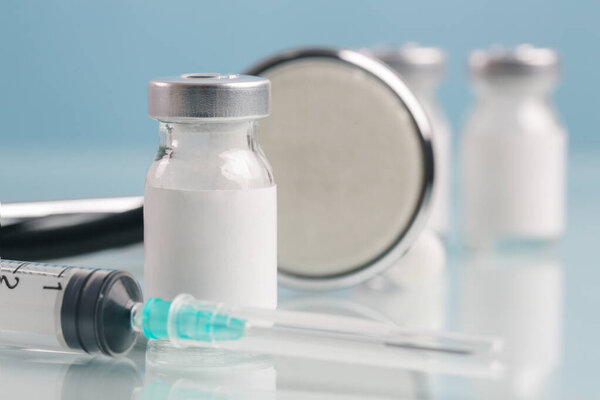 Close up image of vaccine or injection bottles with blank white label.  Vial bottle mockup. Science, vaccination, immunization, health care and medical concept.  