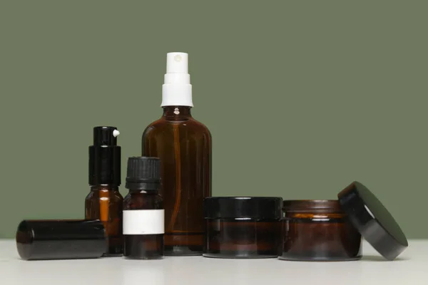 Various Brown Glass Cosmetics Bottles Green Background — Stock Photo, Image