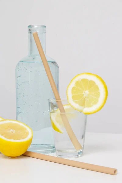 Lemon water with bamboo straw. Healthy detox drink. Reusable bamboo straws as an alternative for single-use plastic straws, healthy and sustainable lifestyle concept