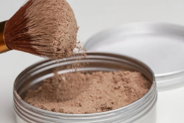 A jar of organic non-toxic chemicals free dry shampoo. DIY project for healthy low toxic living. Simple shampoo powder containing just natural ingredients, cocoa powder, cornstarch and essential oil.