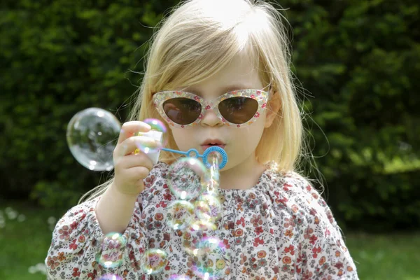Portrait Fashionable Toddler Girl Blowing Soap Bubbles Park — Stock Photo, Image