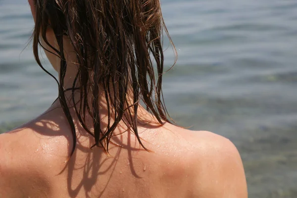 Woman\'s hair on the beach. Wet hair close up image. Hair damage due to salty ocean water and sun, summertime hair care concept.