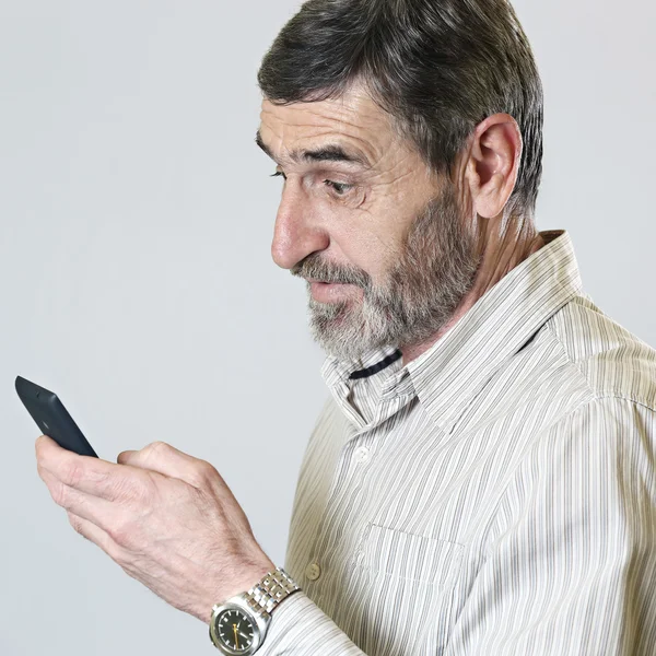 Middle aged man looking at his phone — Stock Photo, Image