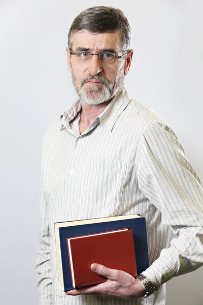 Middle aged man holding books — Stock Photo, Image