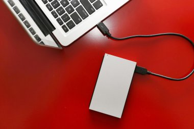 External hard drive connected to laptop clipart