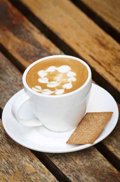 Cup of coffee on wooden table — Stock Photo, Image