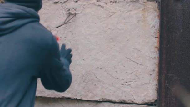 Street huligan Skriva på väggen med hjälp av en sprayfärg kan — Stockvideo