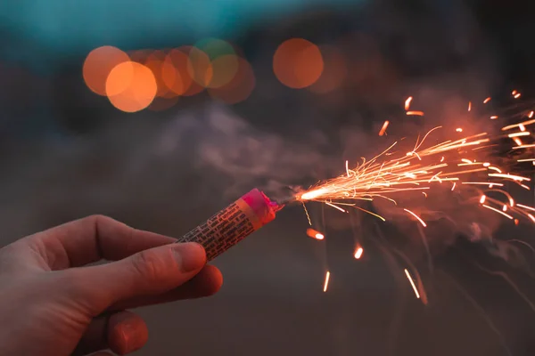 Jongeman verlicht vuurwerk buiten — Stockfoto