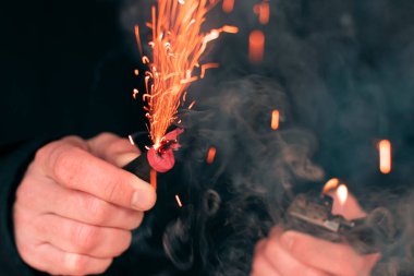 Firecracker Burning in Hand with Sparks and Smoke clipart