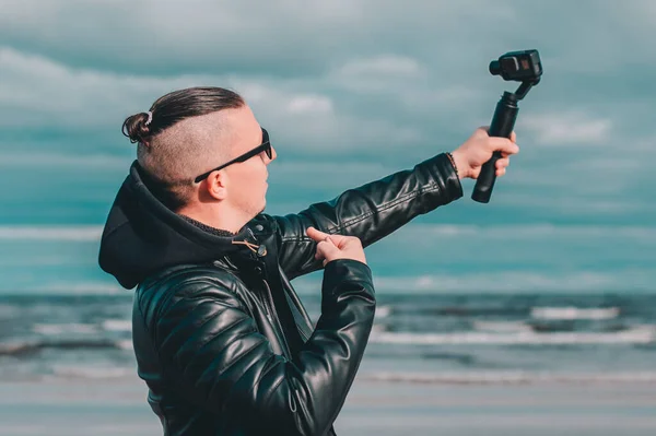 Young Male Hipster Making Selfie Using Action Camera