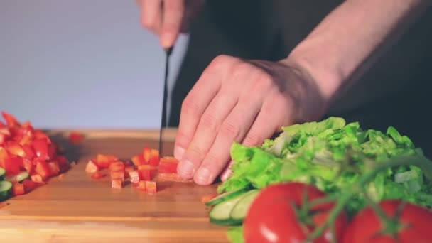 Šéfkuchař krájí červenou papriku na řezací desce — Stock video