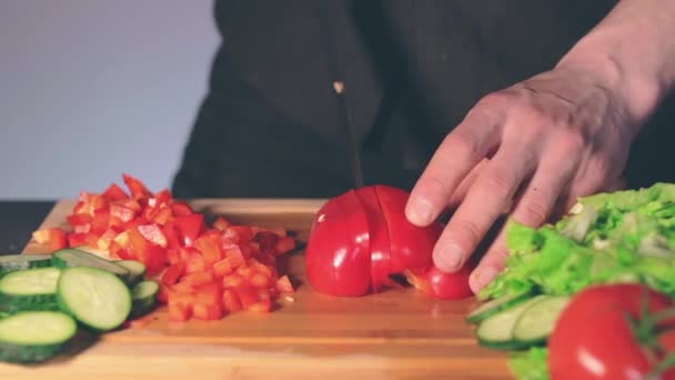 Chef rebanando pimentón rojo en la tabla de cortar — Vídeo de stock