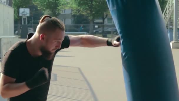 Street Fighter Boxning i boxningssäck utomhus — Stockvideo