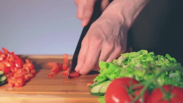 Chef rebanando pimentón rojo en la tabla de cortar — Vídeo de stock