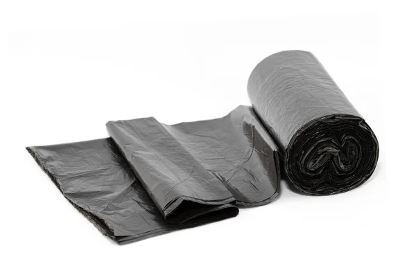Черные полиэтиленовые мешки для мусора на белом фоне — стоковое фото