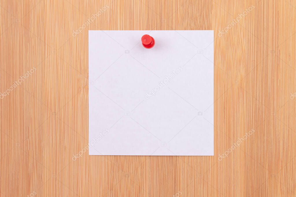 White Sticky Note Pinned to the Wooden Message Board