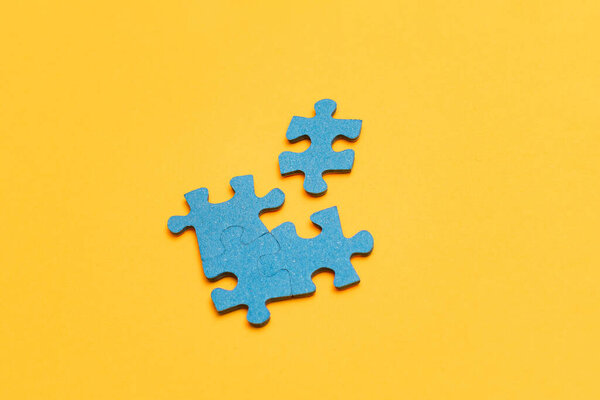 Puzzle Pieces on Yellow Background