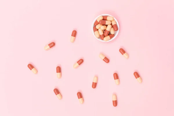 Pharmaceutical Industry and Medicinal Products - Colored Pills on Pink Table — Stock Photo, Image