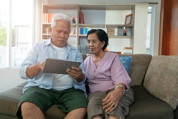 Happy Asian Senior Couple Use Tablet Find Vacation Destinations Holiday — Stock Fotó