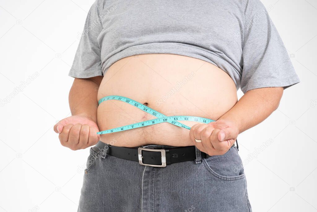 Overweight Man uses a measurement tape for measures his fat belly. isolated on white background. Concept of Healthcare, medicine, and  Weight loss