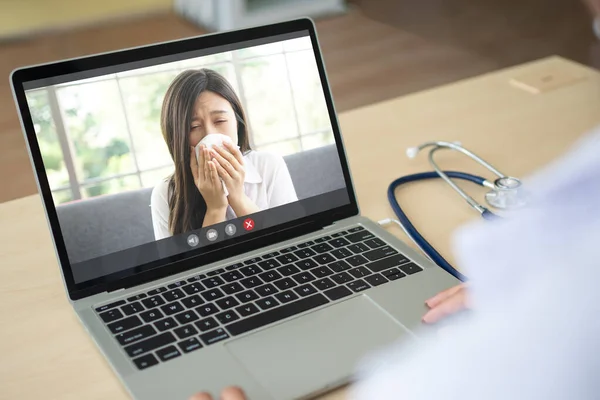The doctor video conference with A sick person with a cold and sneezing and Ask for symptoms of the disease for Diagnosis. Concept of technology and health, online telehealth with the doctor.
