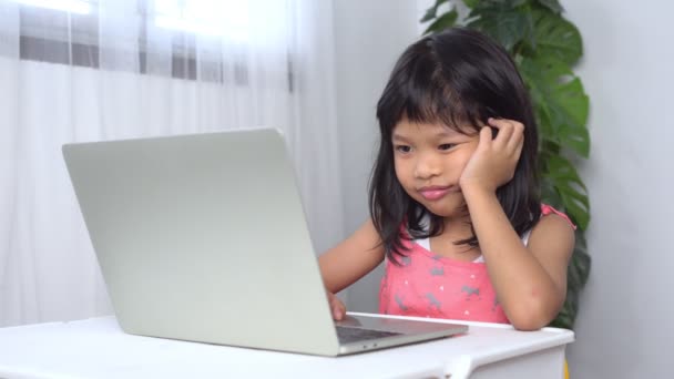 Divertente asiatico bambino apprendimento classe studio online con un video chiamate da un notebook con un insegnante a casa ed era assonnato e si addormentò, concetto di educazione online e homeschool — Video Stock