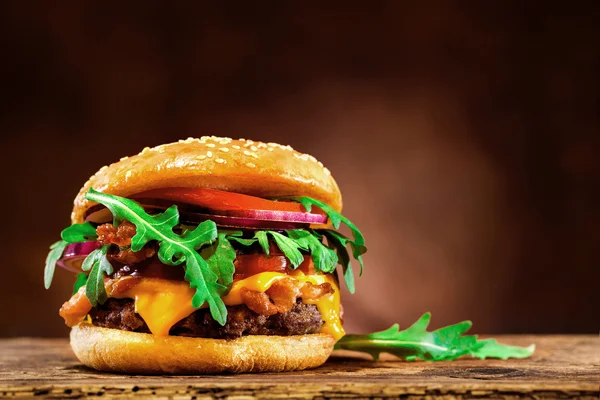 Delicious hamburger on wooden table — Stock Photo, Image