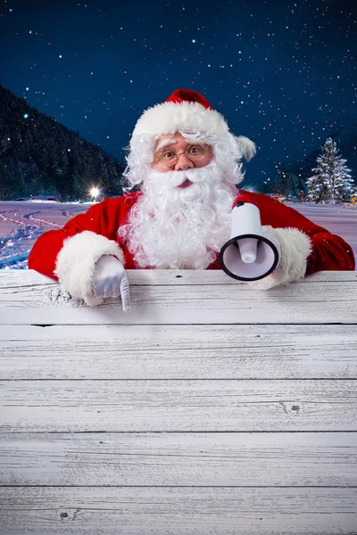 Papai Noel apontando em sinal em branco — Fotografia de Stock