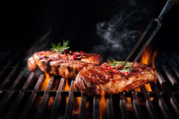 Beef steaks on the grill Stock Image