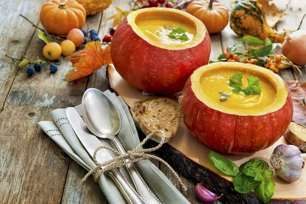 Pumpkin soup on a wooden table — Stock Image Pumpkin soup on a wooden table Royalty Free Stock Images