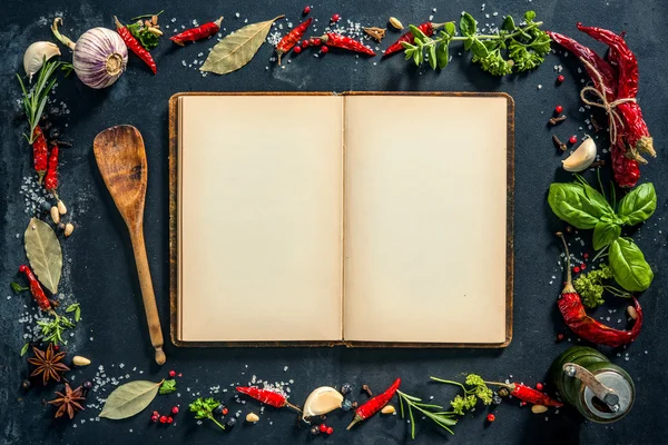 Herbs and spices with a recipe book — Stock Photo, Image