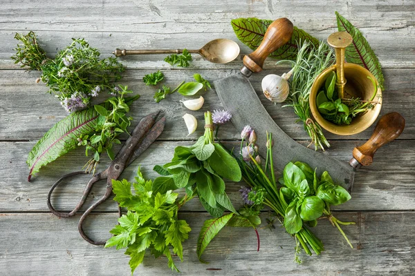 Fresh herbs and spices on wooden table — Stock Photo, Image